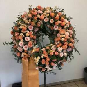 Funeral wreath made from various salmon-coloured roses